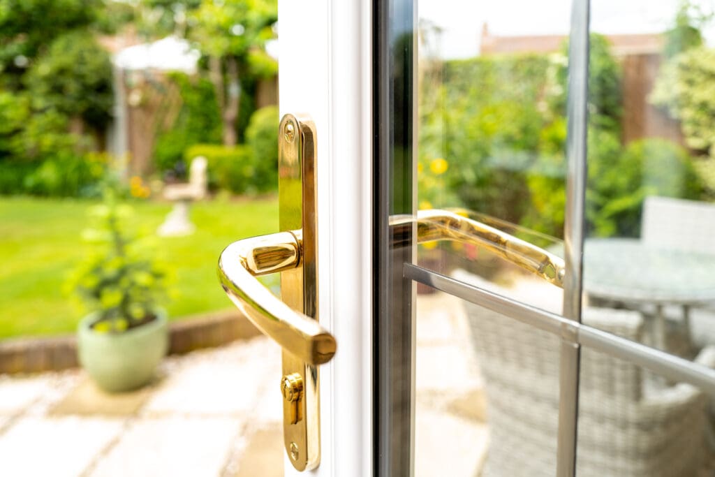 Shallow focus of the keyhole seen on a newly fitted double glazed generic door Leading to a patio area and enclosed garden