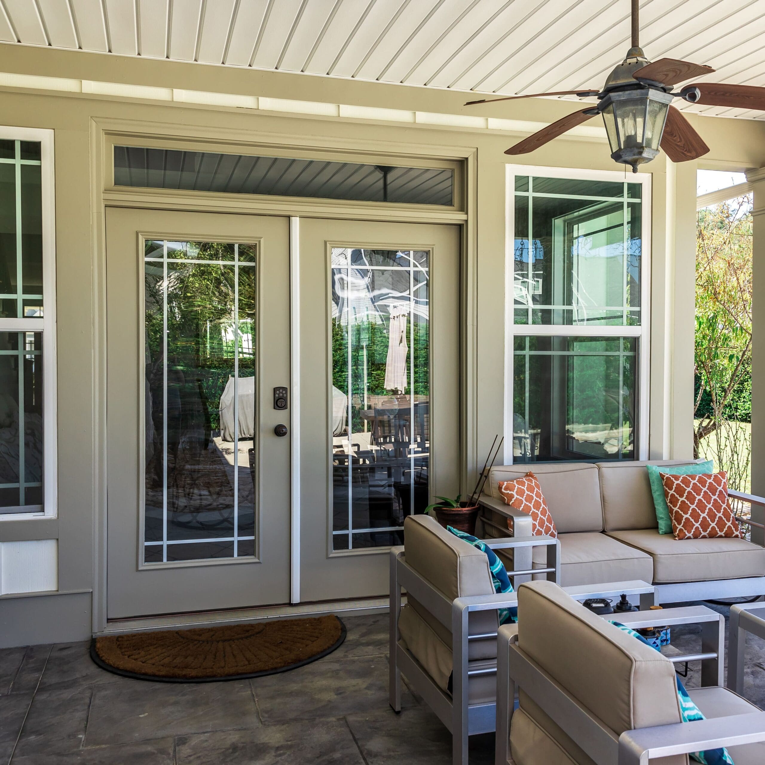 Covered outdoor patio in a new construction house home with guest seating
